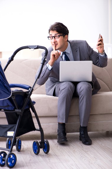 Businessman looking after baby at home